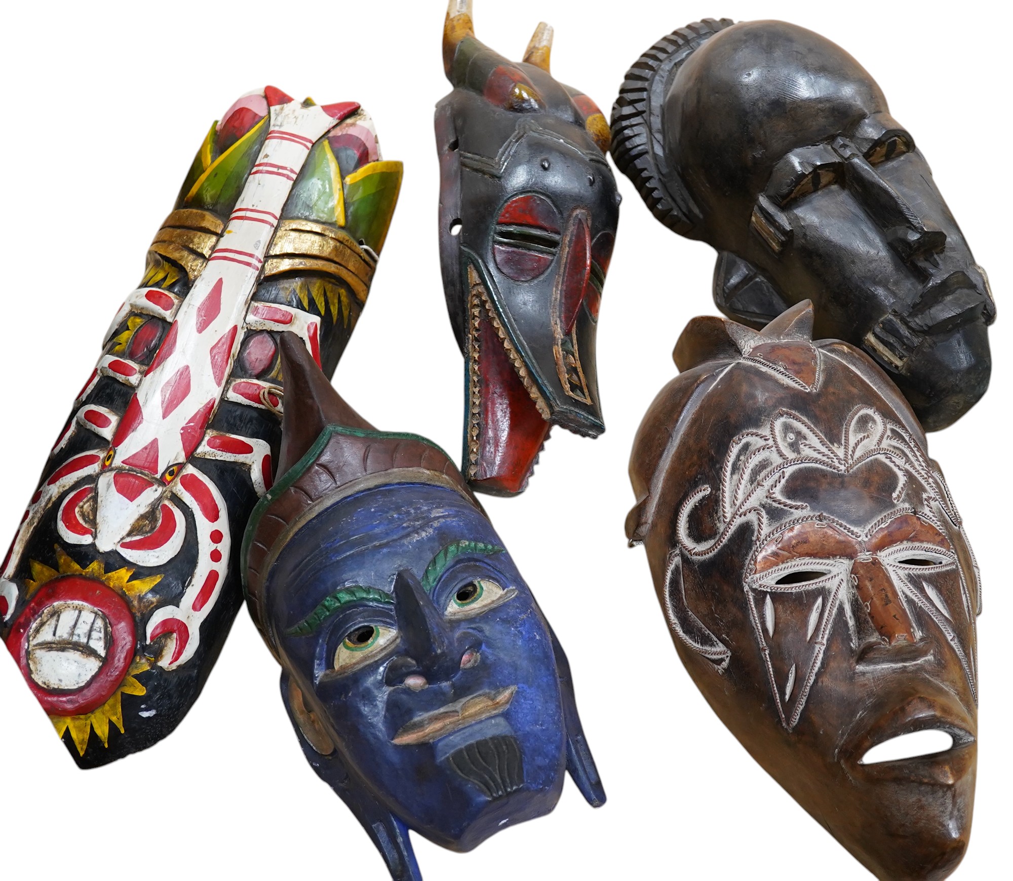 Five various tribal masks and a chip carved panel, 100x45cm. Condition - good